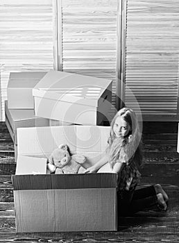 Happy childhood. Relocating family stressful for kids. Kid girl relocating boxes background. Relocating concept