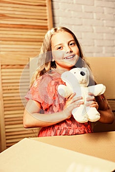 Happy childhood. Small child prepare toys for relocation. Kid girl relocating boxes background. Relocating concept