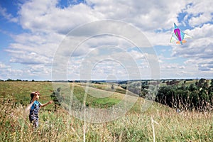 Happy childhood and summertime. Kid having fun and playing with a kite, outdoor