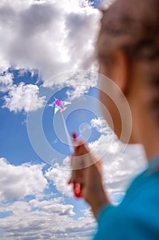 Happy childhood and summertime. Kid having fun and playing with a kite, outdoor