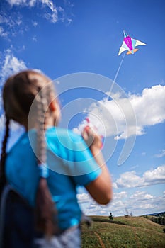 Happy childhood and summertime. Kid having fun and playing with a kite, outdoor