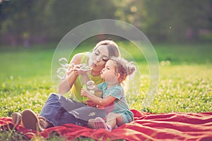 Happy Childhood â€“ Mother and child blows soup foam and make bubbles