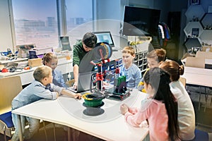 Happy children with 3d printer at robotics school