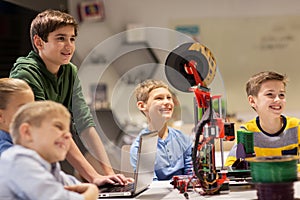 Happy children with 3d printer at robotics school