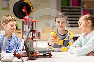 Happy children with 3d printer at robotics school