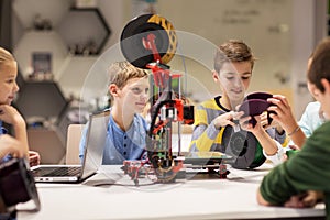 Happy children with 3d printer at robotics school