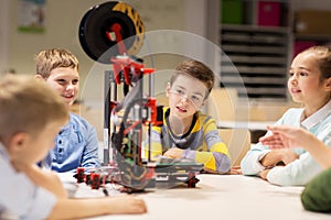 Happy children with 3d printer at robotics school