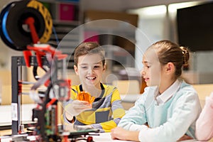 Happy children with 3d printer at robotics school