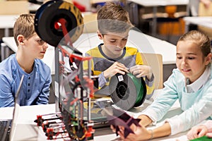 Happy children with 3d printer at robotics school