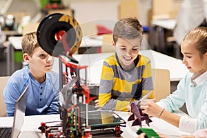 Happy children with 3d printer at robotics school