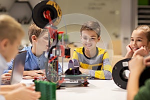 Happy children with 3d printer at robotics school