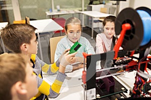 Happy children with 3d printer at robotics school