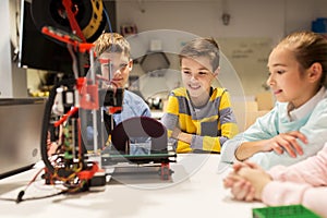 Happy children with 3d printer at robotics school