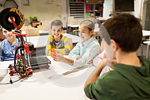 Happy children with 3d printer at robotics school