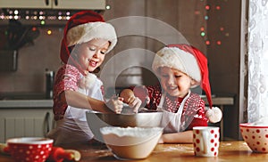 Happy children bake christmas cookies