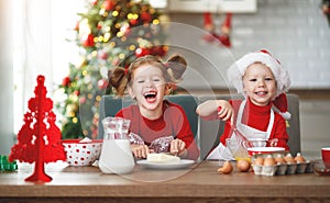 Happy children bake christmas cookies