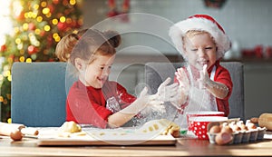 Happy children bake christmas cookies