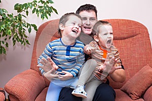 Happy children boys laughing with daddy