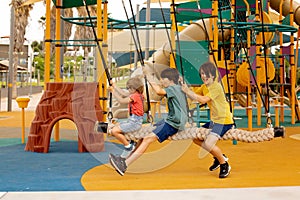 Happy children, boys, playing on playground in Tel Aviv, israel on hot summer day