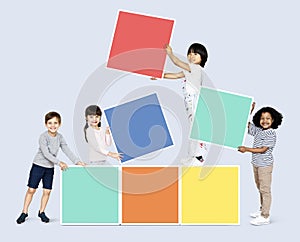 Happy children building colorful blocks
