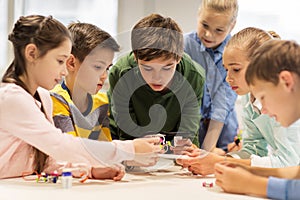 Happy children building robots at robotics school