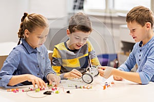 Happy children building robots at robotics school