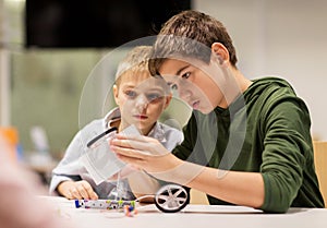 Happy children building robots at robotics school