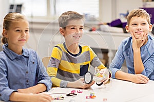 Happy children building robots at robotics school