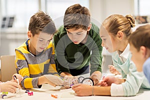 Happy children building robots at robotics school