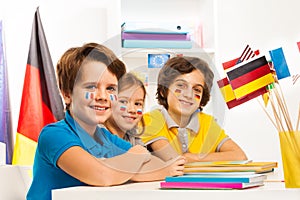 Happy children at the classroom studying geography