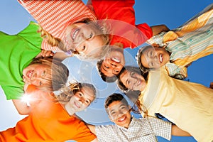 Happy children close in circle on sky background