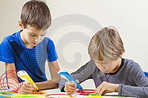 Two boys creating with 3d printing pen