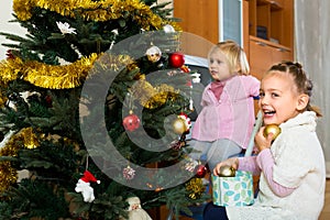 Happy children decorating christmas tree