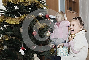 Happy children decorating christmas tree