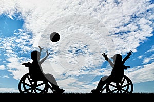 Happy children disabilities in wheelchair play ball day