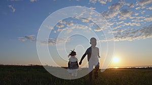 Happy children enjoy playing together on evening meadow