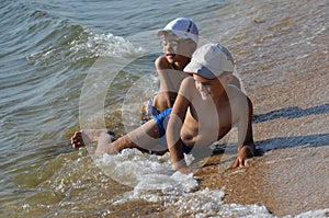 Happy children enjoy the sea waves