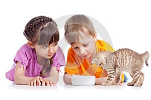 Happy children feeding kitten