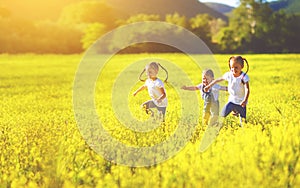 Happy children friends sisters run and play outdoors