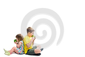 Happy children with fruits. Boy and baby girl eat green apples. isolated on a white background. Healthy food concept, fresh