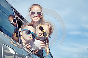 Happy children getting ready for road trip on a sunny day