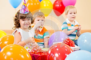 Happy children with gifts on birthday party