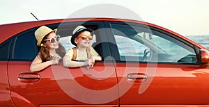 Happy children girl and boy goes to summer travel trip in car