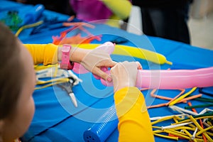 Happy children girl`s hands with balloon on twisting art workshop