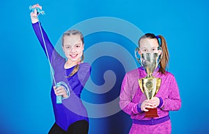 Happy children with gold champion cup. victory of teen girls. Winners in competition. Acrobatics and gymnastics. Little