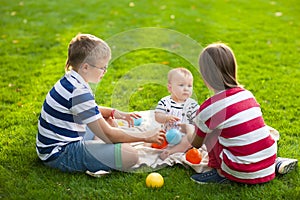 Happy children on green grass in summer park. Healthy lifestyles photo