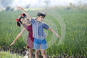 Happy children having fun in agricultural field