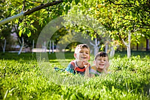 Happy children having fun outdoors. Kids playing in summer park.