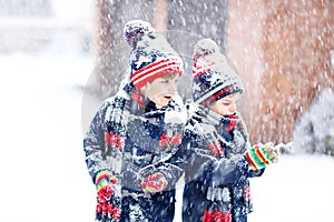 Happy children having fun with snow in winter