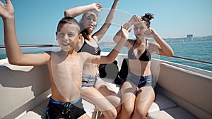 Happy children having a party on a luxury boat dancing